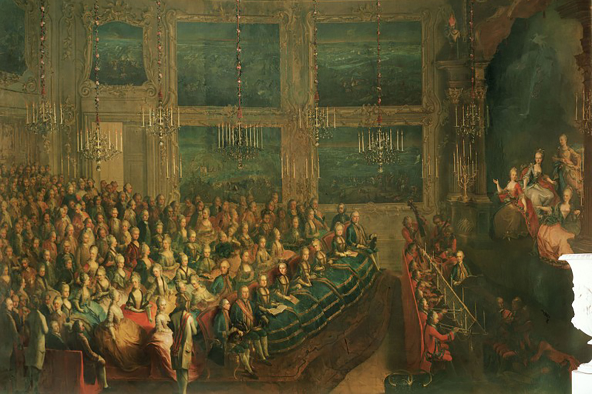 Premiéra azione teatrale Il parnasso confuso libretisty P. Metastasia a skladatele C. W. Glucka, která se odehrává s Schönbrunnském paláci v roce 1765 u příležitosti sňatku Josefa II. Vpravo lze vidět na jevišti dcery Marie Terezie, které Mancini učil zpívat a které tvořily obsazení představení – sopránovou roli Melpomene interpretuje Marie Alžběta. U cembala sedí jejich bratr, budoucí císař Leopold II., který operu hudebně řídí (autor Johann Franz Greipel Greipel)